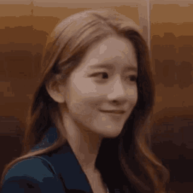 a close up of a woman 's face with a smile on her face .