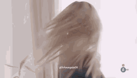 a close up of a woman 's hair blowing in the wind .