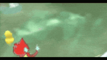 a yellow rubber duck is swimming next to a red object