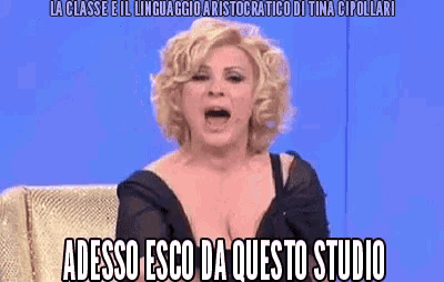 a woman is sitting on a couch with her mouth open and a caption that says adesso esco da questo studio