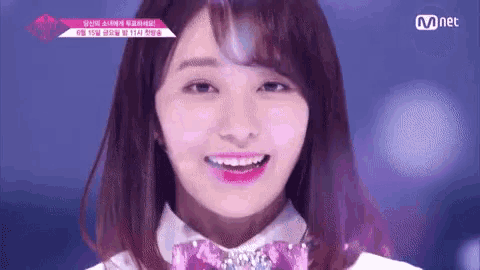 a close up of a woman 's face with a purple bow tie and pink lipstick .