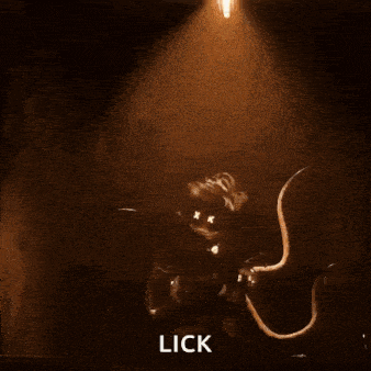 a monster is licking a beam of light from a spotlight .