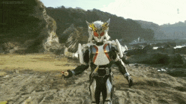a man in a superhero costume is standing on a beach near a body of water