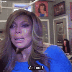 a woman in a blue shirt says get out