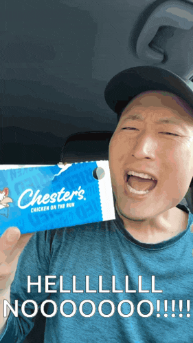 a man is holding a chester 's chicken on the run box