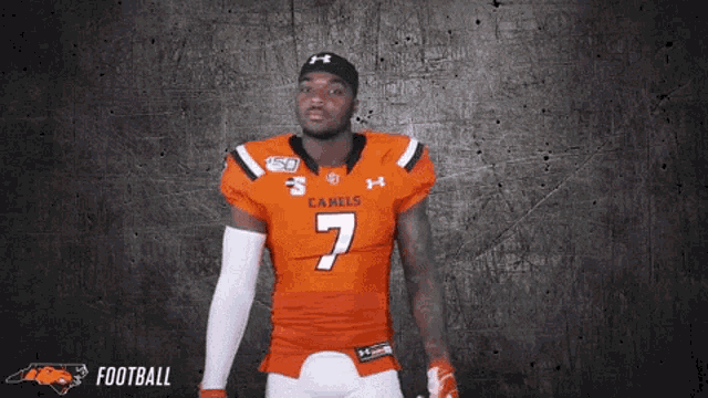 a football player wearing an orange jersey with the number 7