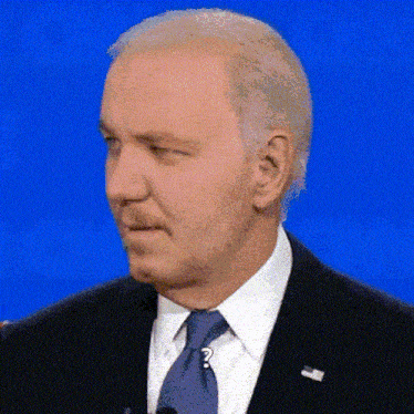 a man in a suit and tie has a question mark on his tie
