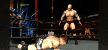 two wrestlers in a wrestling ring with a sign that says divas in the background