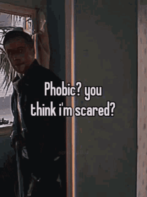 a man standing in a room with the words phobia ? you think i 'm scared ?