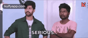 two men are standing next to each other with their arms crossed and one of them says `` serious '' .