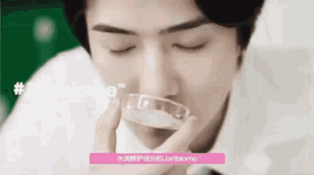 a man is holding a petri dish in front of his face ..