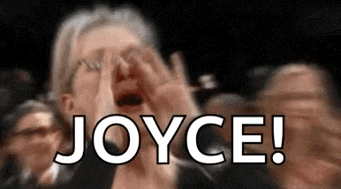a woman is screaming in front of a crowd and the word joyce is written on the screen .