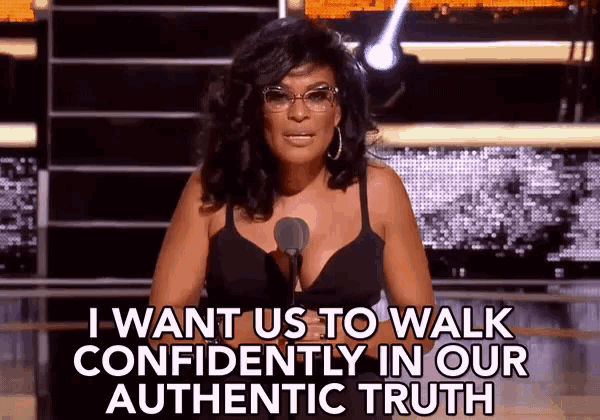 a woman speaking into a microphone with the words " i want us to walk confidently in our authentic truth "