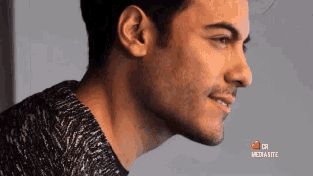a close up of a man 's face with the words cr media site on the bottom right