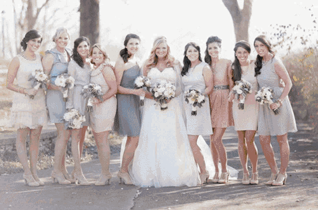 the bride and her bridesmaids pose for a photo