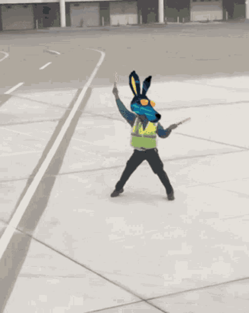 a man with a rabbit head on his head is standing on a concrete surface