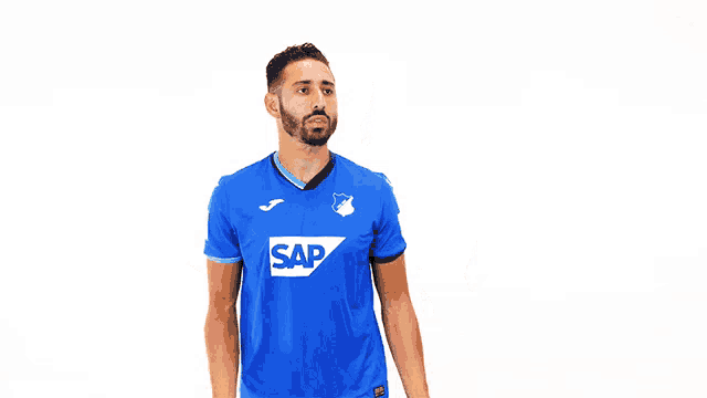 a man wearing a blue shirt with the word sap on the front