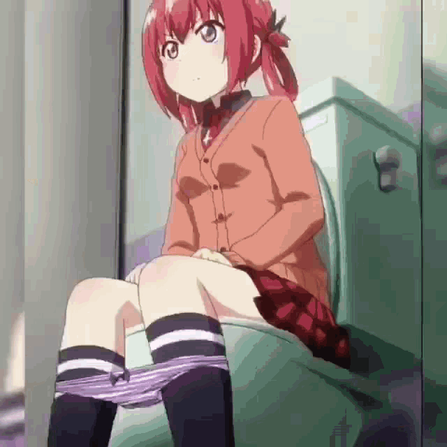 a girl with red hair is sitting on a toilet with her underwear down .