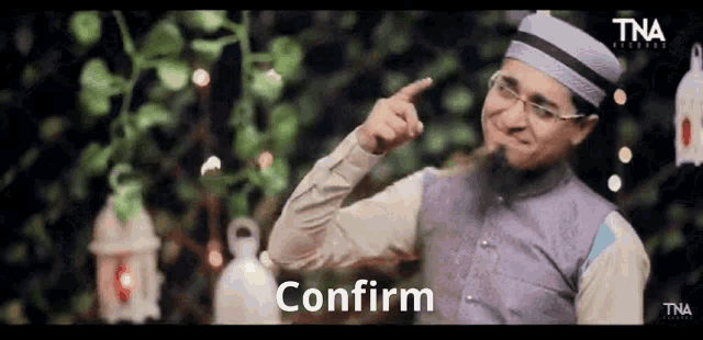 a man wearing a hat and glasses is pointing at something with the word confirm below him