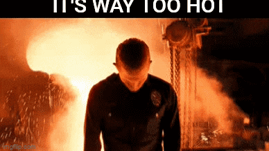 a man standing in front of a fire with the words it 's way too hot