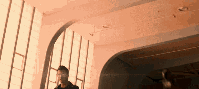 a man stands in front of a window in a room