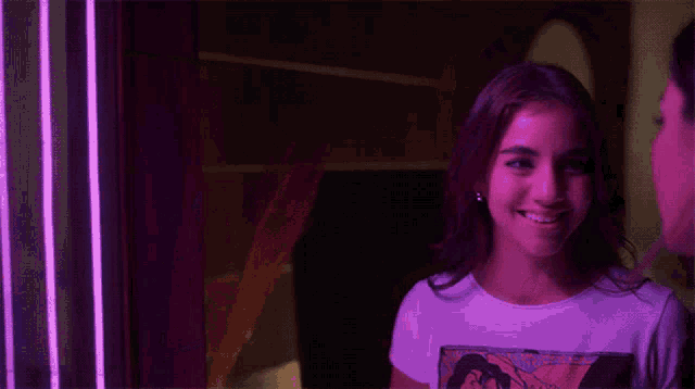a woman wearing a purple shirt with a picture of a woman on it