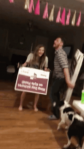 a man and a woman are holding a sign that says nine day pictures