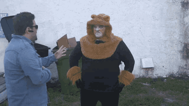 a man in a bear costume talks to another man