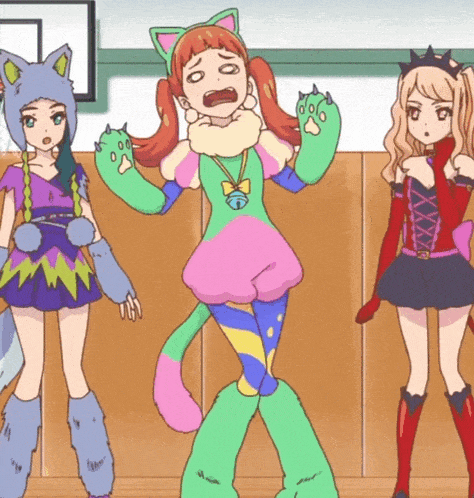 a girl in a cat costume is standing between two other girls