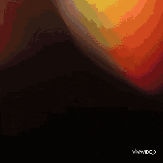 a woman is standing with her arms crossed in front of a blurred background with the words vivavideo visible