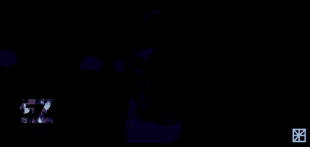 a man is standing in a dark room with a sign that says 57 millions