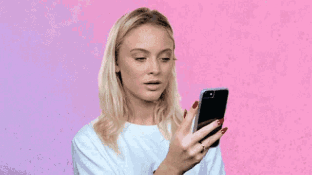 a woman is taking a selfie with her phone .