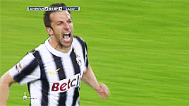 a blurry picture of two soccer players with the word juventus on the bottom left