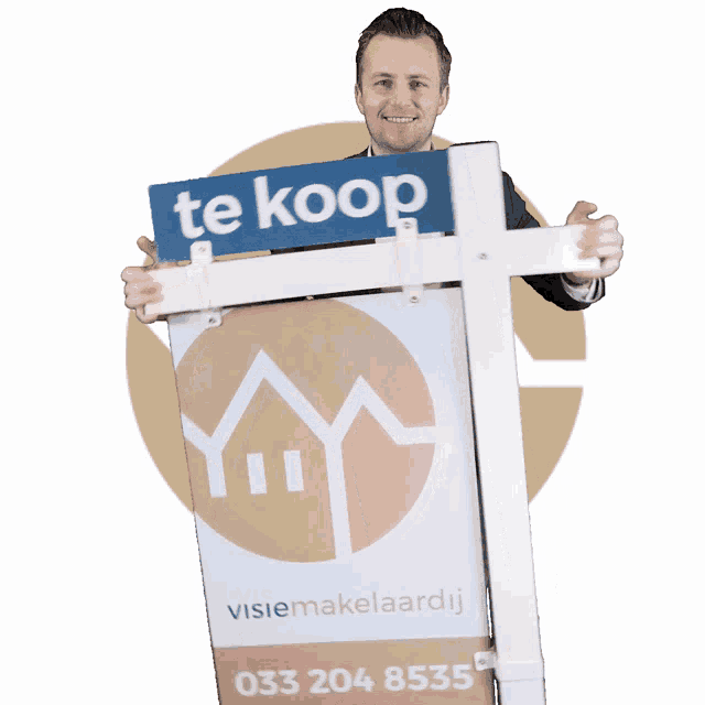 a man in a suit holds up a te koop sign