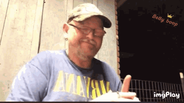 a man wearing a hat and a shirt that says nirvana on it