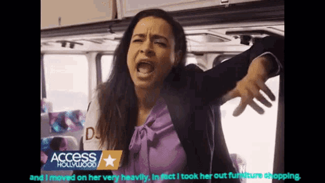 a woman is screaming on a bus with access hollywood in the corner