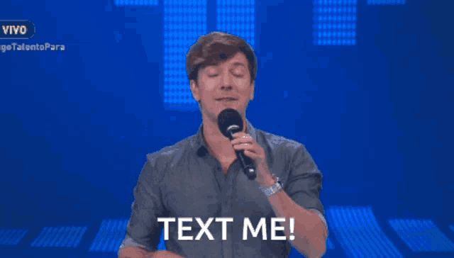 a man singing into a microphone with the words text me above him