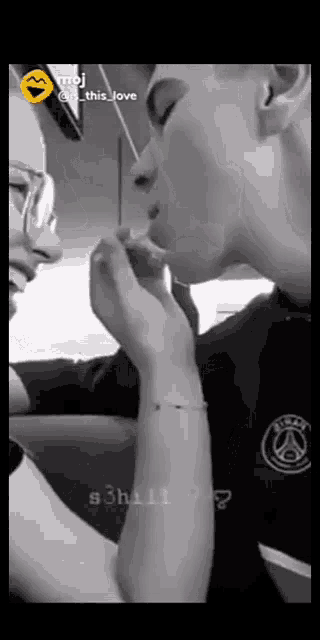 a black and white photo of a man and woman kissing with the caption " this love "
