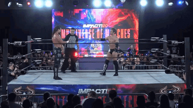 two men in a wrestling ring with a sign that says impact