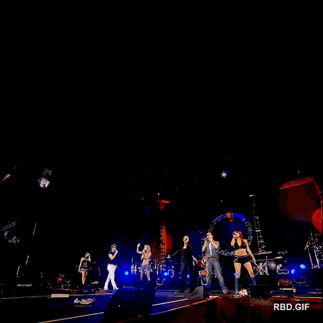 a group of people singing on a stage with a watermark that says rbd_gif