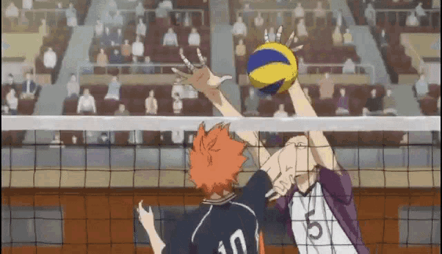 two volleyball players are playing a game of volleyball in a stadium .