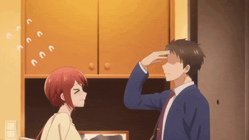 a man and a woman are looking at each other and the man is touching the woman 's forehead