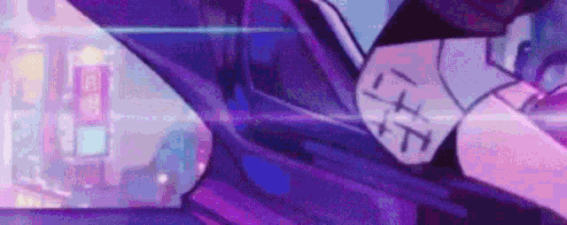 a close up of a person 's arm in a car with a city in the background .
