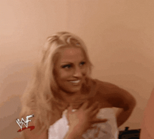 a woman is wrapped in a towel with a wwe logo on her chest .