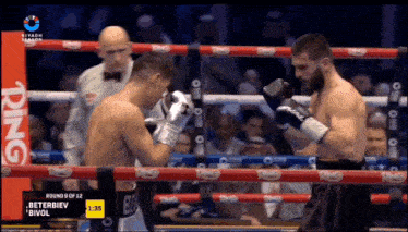 two boxers are fighting in a ring with ring written on the side