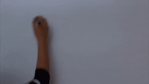 a person is writing the letter m on a whiteboard
