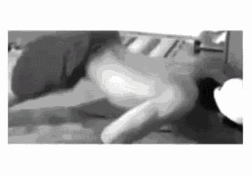 a black and white photo of a person laying on a bed with a white background .