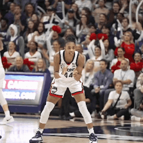 a female basketball player wearing a white jersey with the number 44 on it