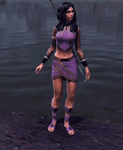 a woman in purple shorts is laying on the ground near a body of water