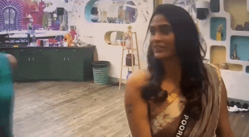 a woman wearing a saree with the word poori on the waist